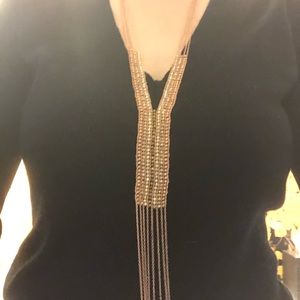 Rose gold colored beadwork statement necklace.